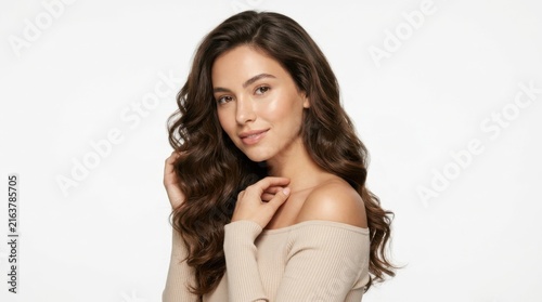 Beautiful young woman with long wavy brown hair smiling at the camera