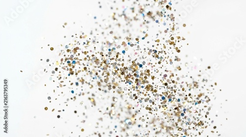 Multicolor glitter and confetti floating on white background