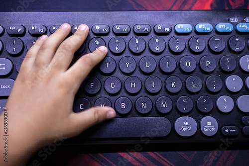 Child hand Typing on Computer Keyboard While Learning Digital Skills