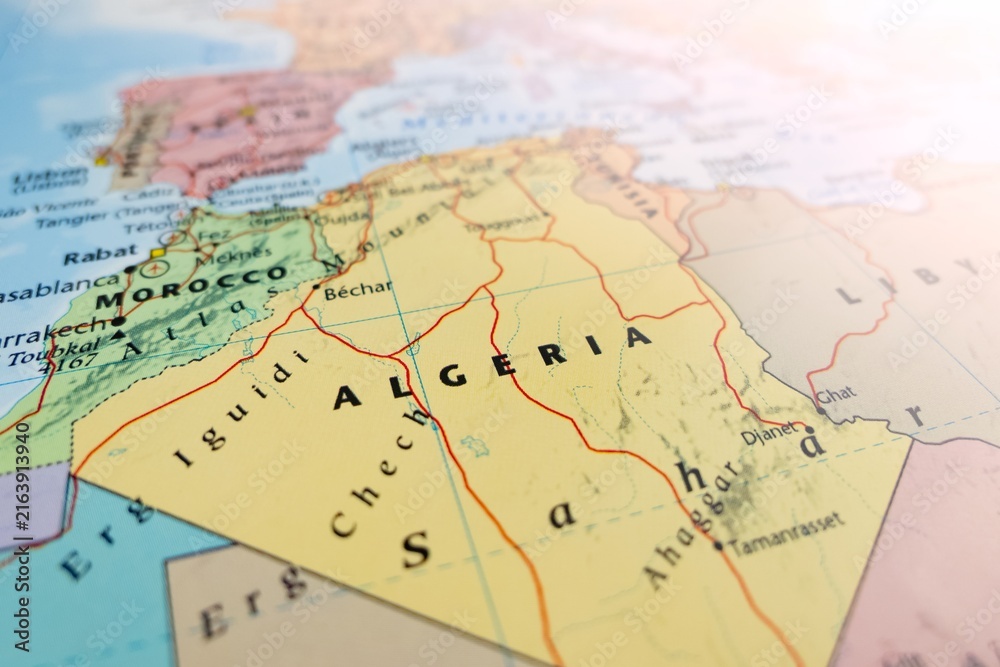 Fototapeta premium Map of Algeria with flare from top right corner. Selective focus on label, close-up view