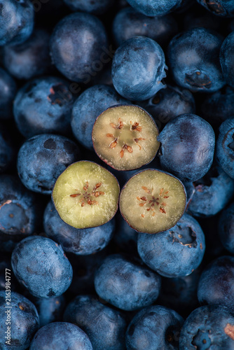 Fresh blueberries with one cut berry macro close up. Top view.