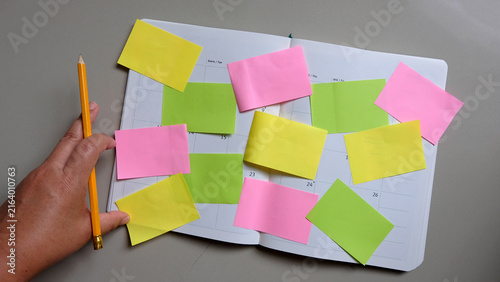 Multiple sheets sticky notes on notebook. brainstorm, planning concept.
