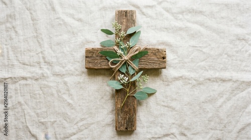 Wooden Cross with Green Leaves on White Fabric