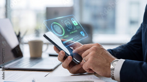 Smartphone fingerprint security access digital authentication businessman holding mobile phone office desk laptop blur background