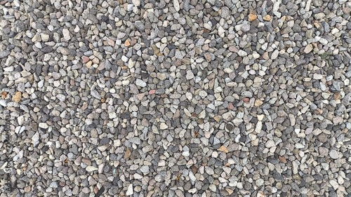 Obraz na płótnie Top down collection of assorted smooth river pebbles featuring natural colors, irregular shapes, and detailed surfaces, ideal for stone textures, landscape design, garden decoration