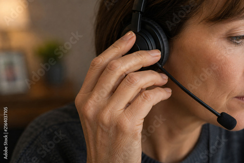 Professional woman wearing a headset microphone while working in customer service or a call center