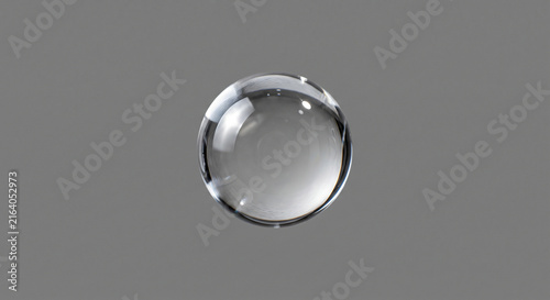 A perfectly spherical clear glass marble or crystal ball floating against a plain grey background with subtle reflections and refractions