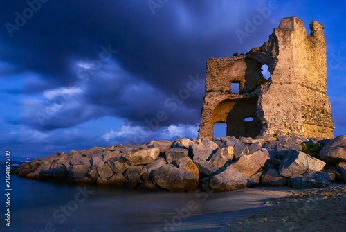 Photography Ancient ruined watchtower on the sandy beach of Briatico during twilight, Vibo Valentia, Calabria, Italy
