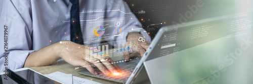 Business professional using AI-powered analytics and coding tools to manage data, automate workflows, monitor performance, and support software development through intelligent digital technology.