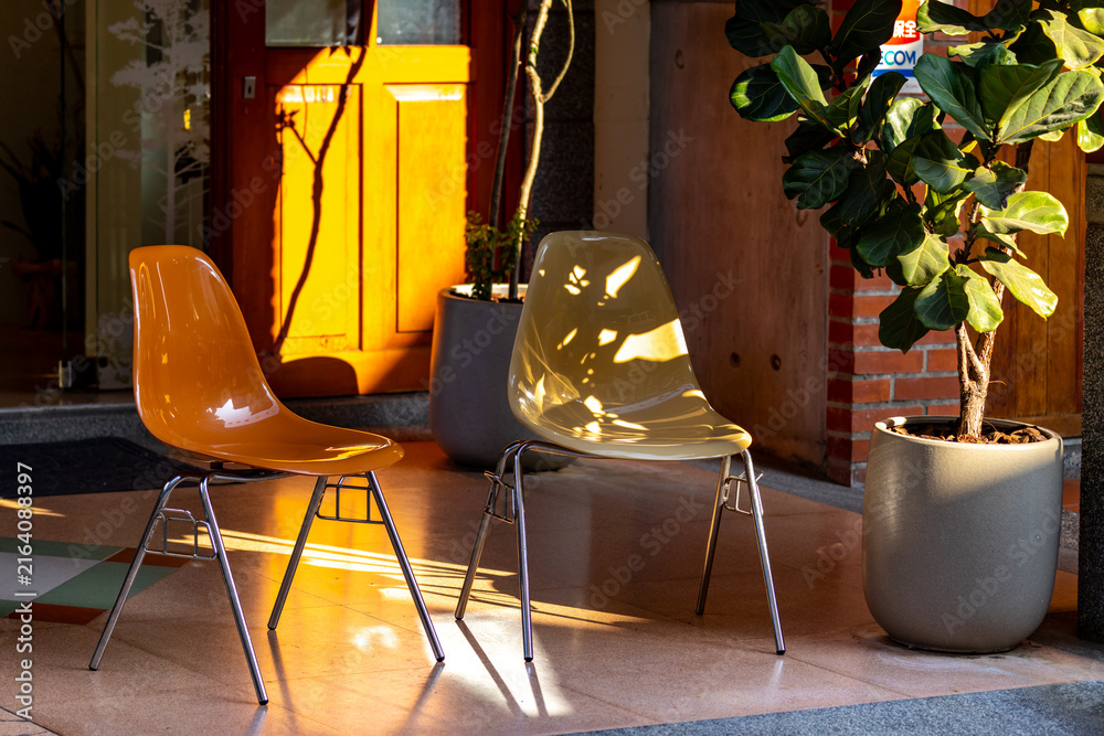 Fototapeta premium Modern Transparent Chairs in Warm Sunlight