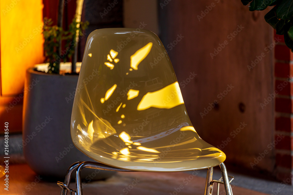 Fototapeta premium Modern Transparent Chairs in Warm Sunlight