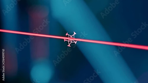 Laser beam emitted from a device creates visible patterns in a dark environment, showcasing the interaction of light with surrounding elements in a scientific setting