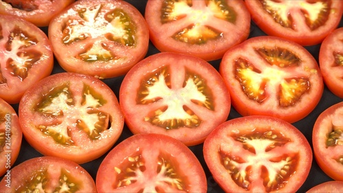 Obraz na płótnie Fresh red tomatoes whole, cut half with knife on wooden board, and sliced texture pattern