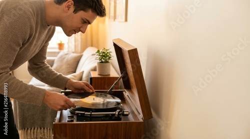 Man Playing Vinyl Record on Turntable in Cozy Living Room
