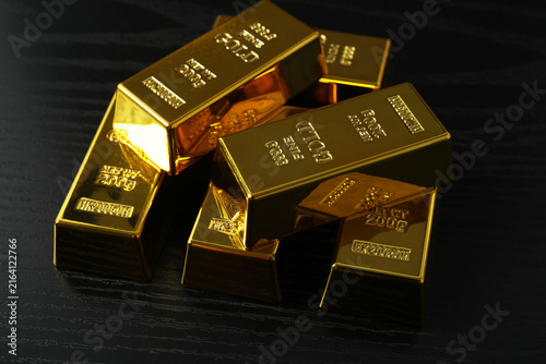 Gold bars or bars as a metal for storage in the bank, investments and financial transactions. Gold bars as a background for your design
