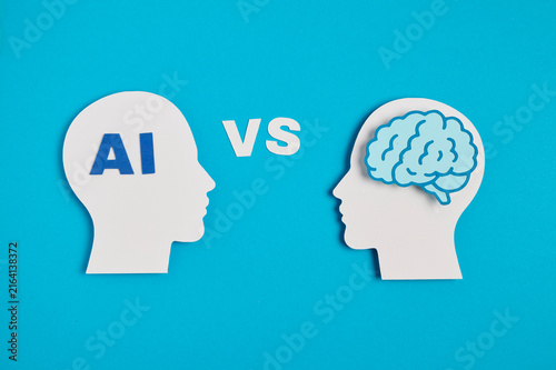 AI vs human brain concept with VS text between silhouettes