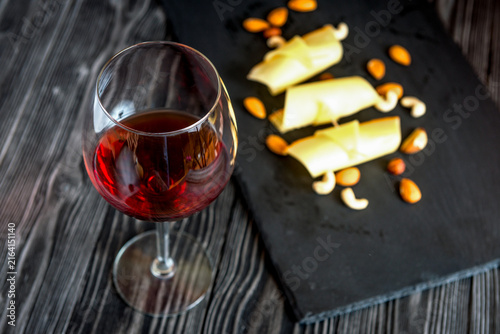 red wine with cheese on wooden background top view