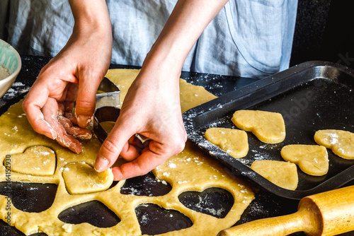 cooking homemade cookies with hands on dark background