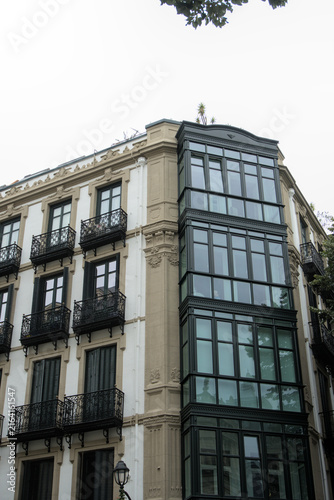 Foto Corner of a historic town house with glazed miradors and iron balconies