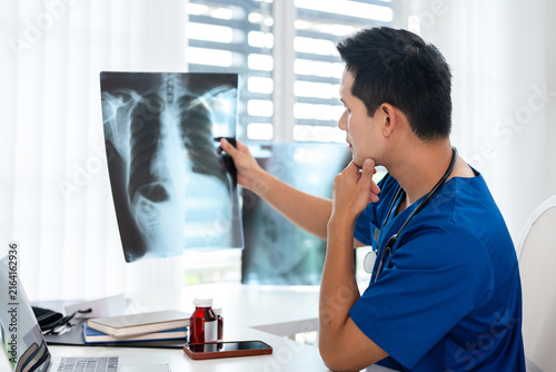 Quadro su tela Doctor radiology  holding x-ray film , reviewing patient diagnosis results in clinic