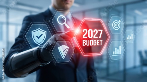 Businessman interacting with futuristic virtual budget interface for fiscal year 2027 planning.