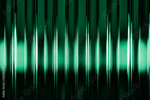 Abstract green reeded glass texture with vertical light refraction lines background