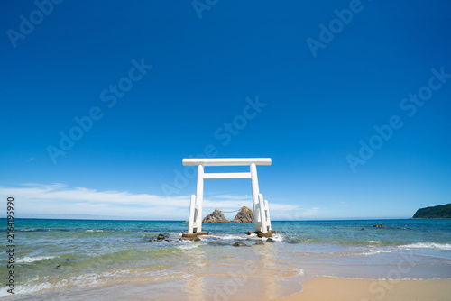 Meoto Iwa, white torii gate standing in the sea with sacred rocks in Itoshima, Fukuoka, Japan