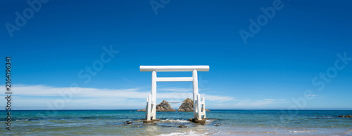 Meoto Iwa, white torii gate standing in the sea with sacred rocks in Itoshima, Fukuoka, Japan
