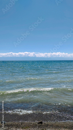 Blue reservoir with waves under a beautiful cloudy sky