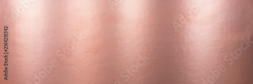 Rose gold metallic texture background, elegant copper foil surface with soft light reflections, luxury pink metal sheet backdrop for premium branding, decorative shimmering bronze paper