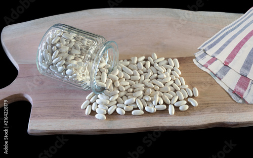 haricots blanc sec présenté sur planche en bois