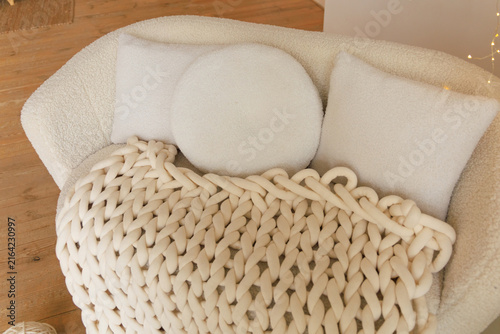 Quadro su tela Cozy seating area with soft pillows and a chunky blanket in a warm room