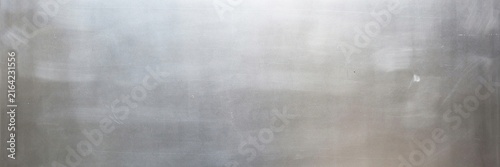 Industrial brushed metal texture with horizontal grain, silver stainless steel surface background, metallic gray aluminum plate for construction and manufacturing design projects