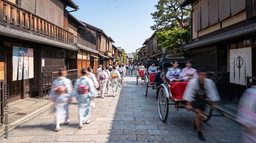 Tourists in Traditional Kimono and Rickshaws in Historic Kyoto Street
