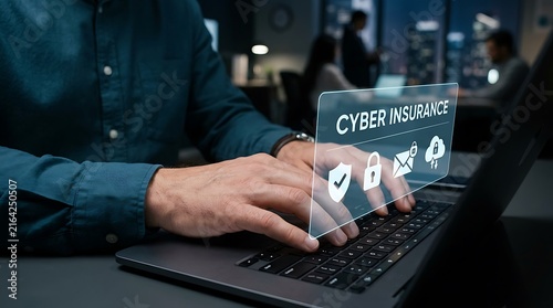 Professional typing on laptop with digital cyber insurance interface in office environment
