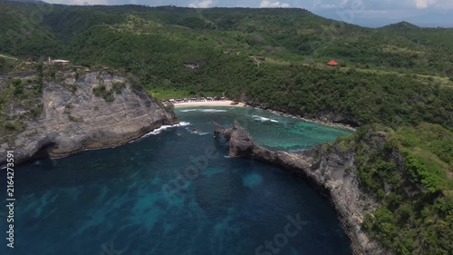 Dramatic aerial view approaching the spectacular atuh beach and its rock formations in bali