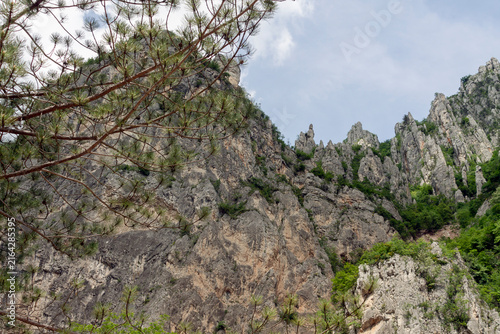 Stone structures and cliffs on top of the hill. view from the foothills. Real photo. Adobe RGB color profile.