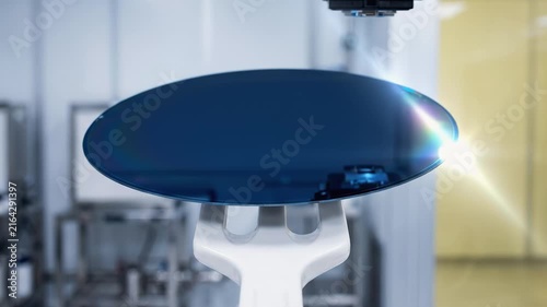 Silicon wafer holding on robotic arm during inspection process in cleanroom semiconductor facility