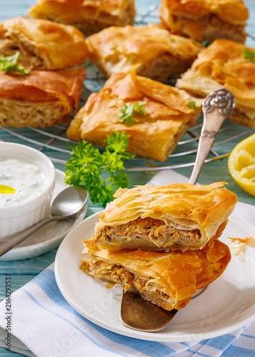 Minced beef pastry slices stacked on a spatula