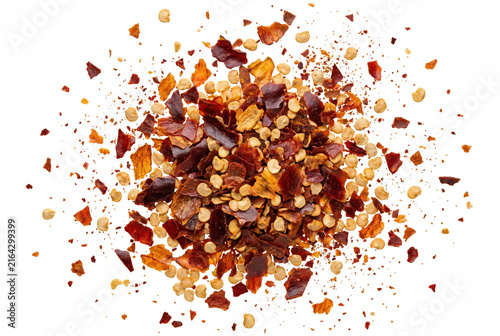 фотографія Crushed Red Chili Pepper Flakes and Seeds Spilled on Dark Surface
