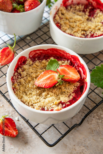 Canvas Print Traditional English crumble cake with strawberry with backed topping  of oatmeal flour, butter and sugar in a baking dish on a stone countertop