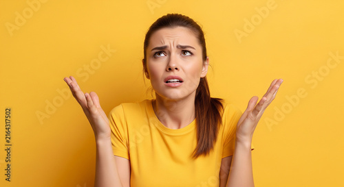 Beautiful woman shrugging shoulders questioning yellow which is perfect for corporate success presentation and advertising
