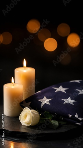 Folded American flag candles and rose for September 11