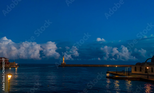 Chania Lighthouse set against a deep blue dawn sky in the historic Old Venetian Harbour of Chania, Crete, Greece
