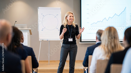 Beautiful woman woman leading workshop presentation room which is perfect for corporate success presentation and highly effective marketing campaigns