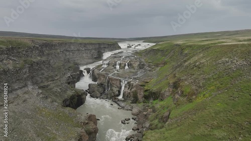 Aerial Drone Shot of Multiple Waterfalls Cascading Down Dramatic Canyon Gorge in Iceland Highlands