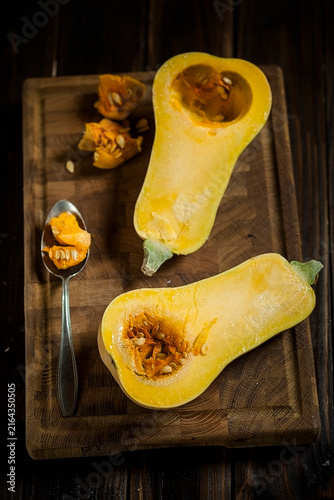 Deseeding a butternut squash, Cucurbita moschata, with a spoon