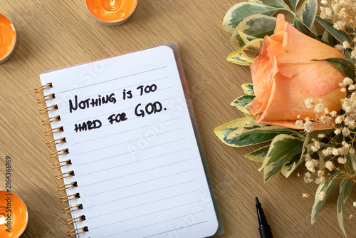 Inspirational christian quote for God's power and authority and faith in Jesus Christ in a notebook with holy bible on a wooden background. Biblical concept.