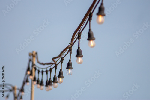 Glowing Festoon Lights Against Sky