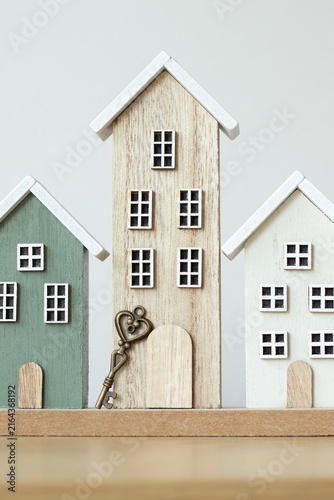Houses and key with white background. Buying and selling real estate, new home, security and investment concept.